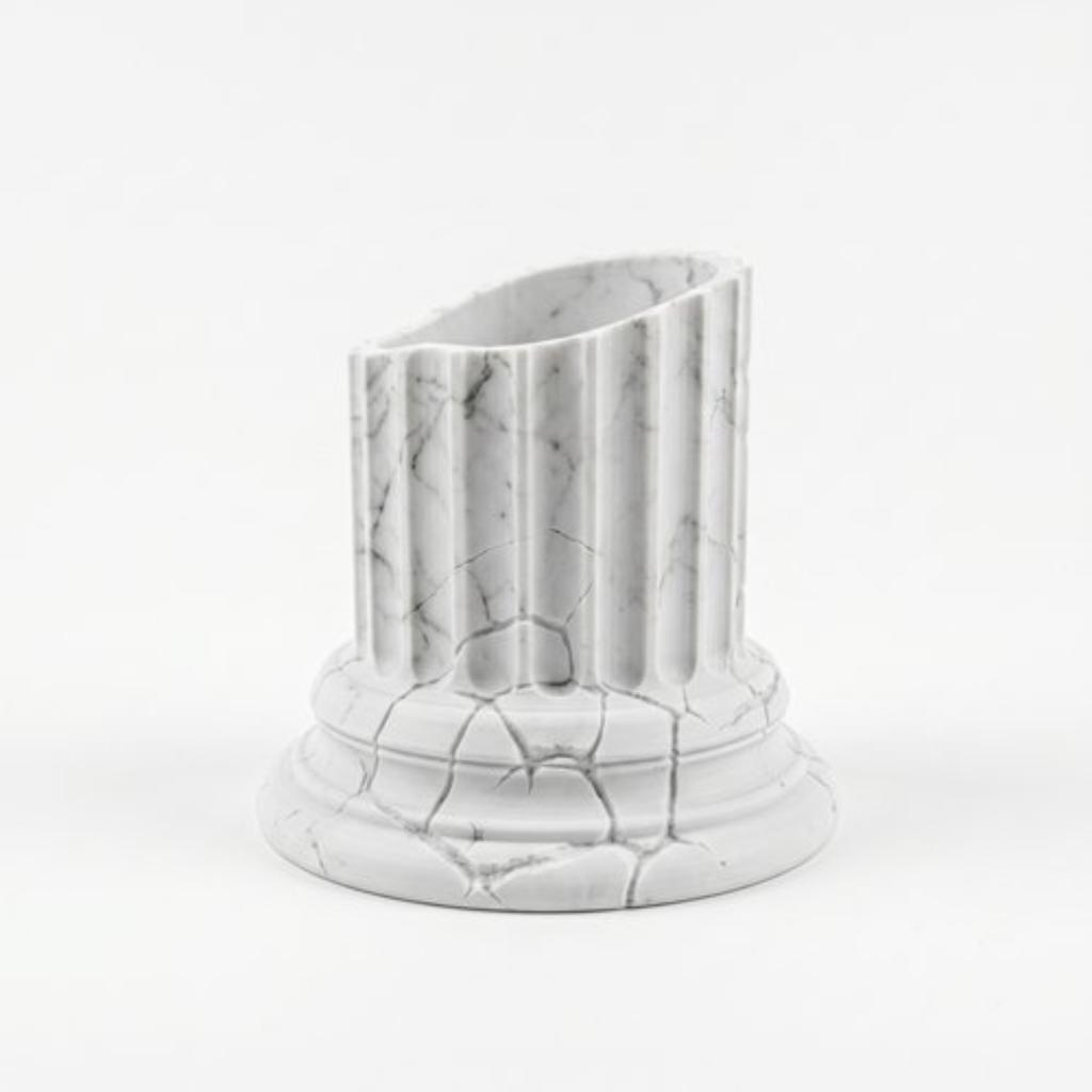 A White Designer Flowerpot In the Shape of a Greek Column for Plants