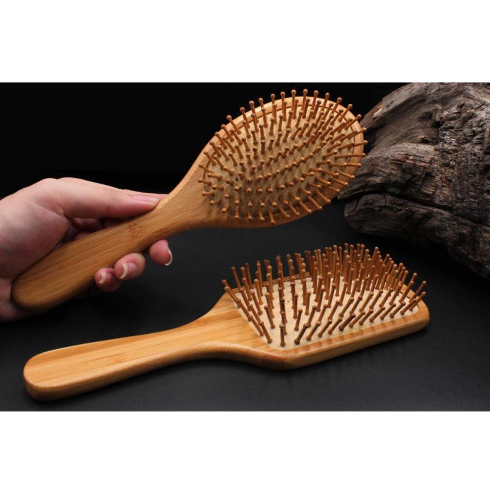 Natural wood paddle comb with bamboo bristles to detangle hair, suitable for women, men, and children, reduces frizz and massages the scalp