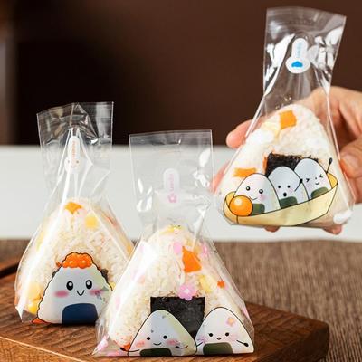 50 pièces Sac de conditionnement transparent pour boules de riz Sac jetable de qualité alimentaire pour sushi Sac triangle à motif dessin animé Emballage alimentaire