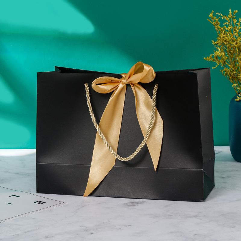 In-Stock White Cardboard Gift Bags with Bow Handle, Customizable Logo for Clothing Stores