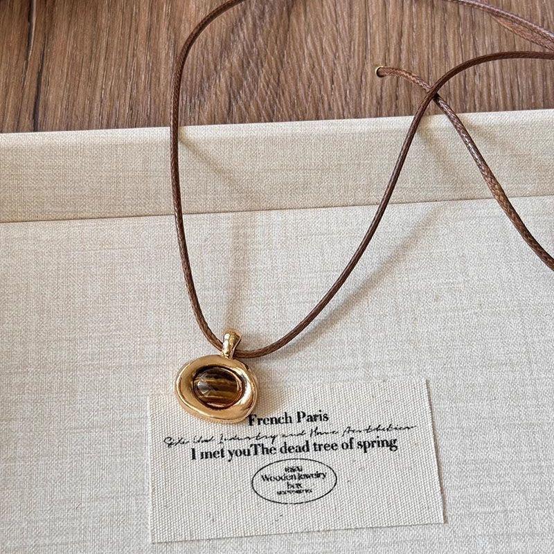 Autumn and winter tiger's eye stone leather rope pull necklace female Merad Yadan long sweater chain simple and fashionable collarbone chain