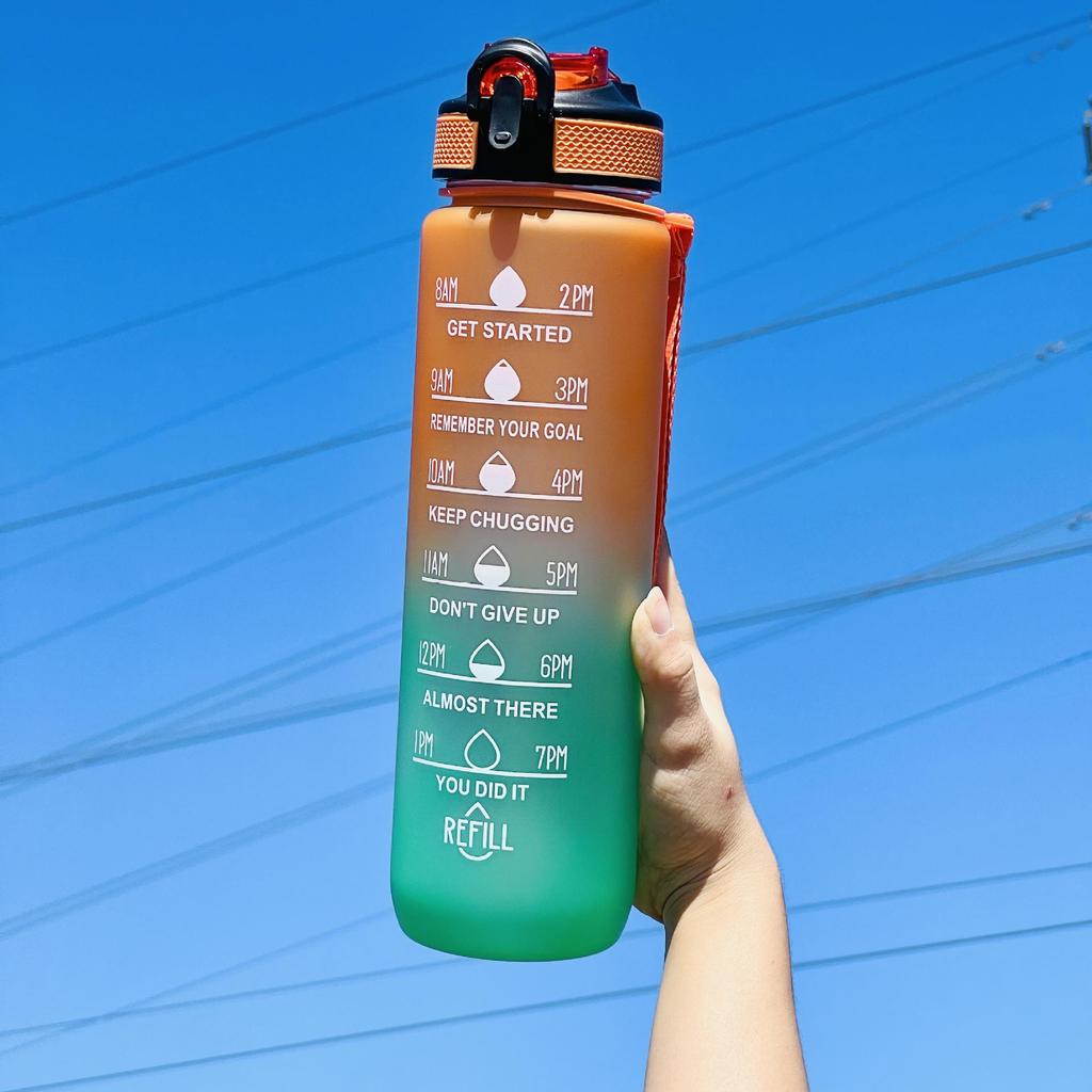 Gradient Large Capacity Sports Water Bottle with Scale, Portable Rope, and Bouncing Straw.