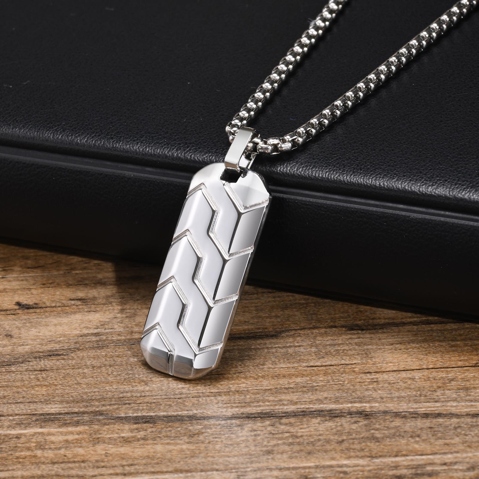 

A stainless steel geometric bar pendant necklace with a cool tire pattern, perfect for men and a stylish punk-inspired gift.