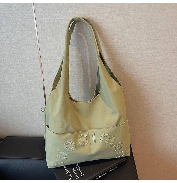 

Korean version of college style large-capacity bag women s 2025 new trendy fashion letter tote bag versatile shoulder armpit bag