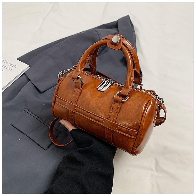 Fashion hand-held bowling bag women's 2025 autumn new simple niche trend commuter PU shoulder messenger women's bag