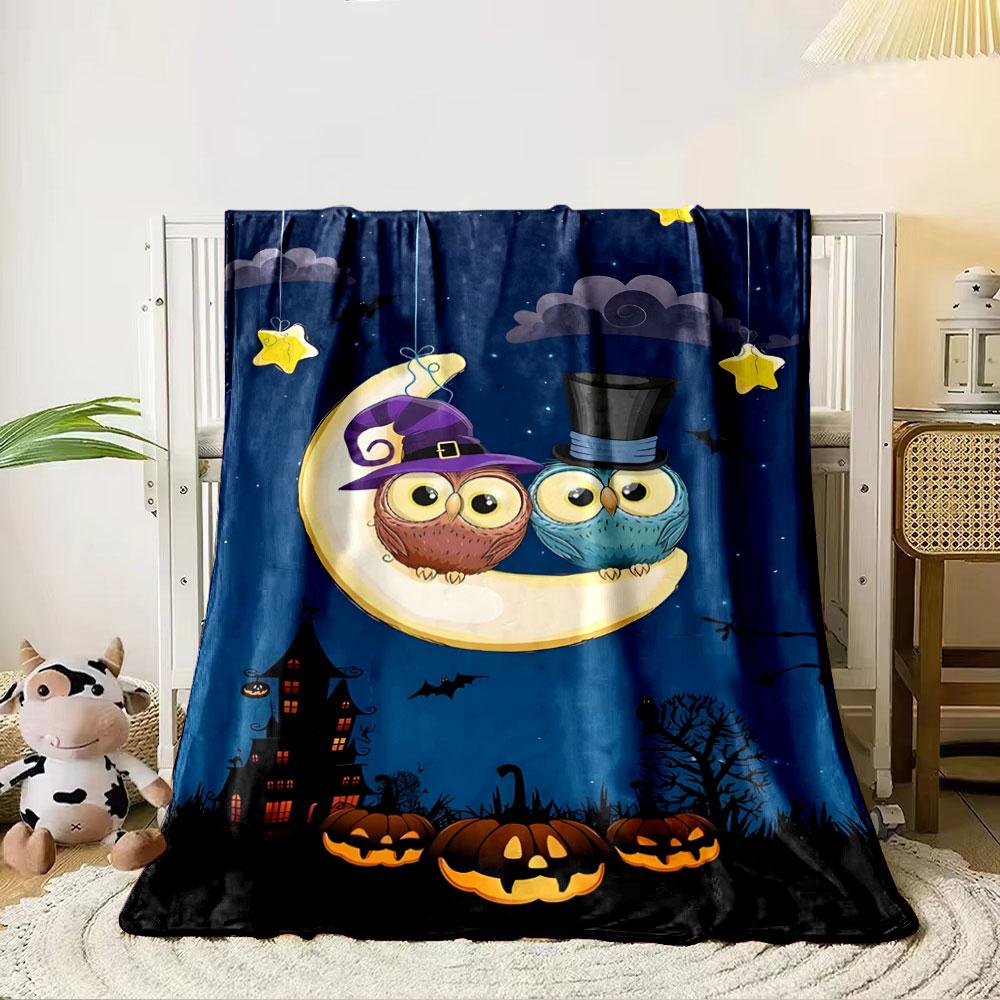Owls in festive hats sit on a crescent moon above pumpkins and bats. for all seasons blanket lunch break throw gift 80cm x 120cm