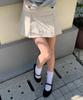 Letter From Moon Mude Buckle Pleated Skirt (Cream)