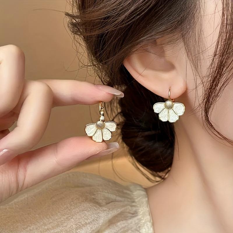 A pair of elegant French-style floral drop earrings, featuring a delicate four-petal flower design, perfect for everyday wear, parties, and vacations.