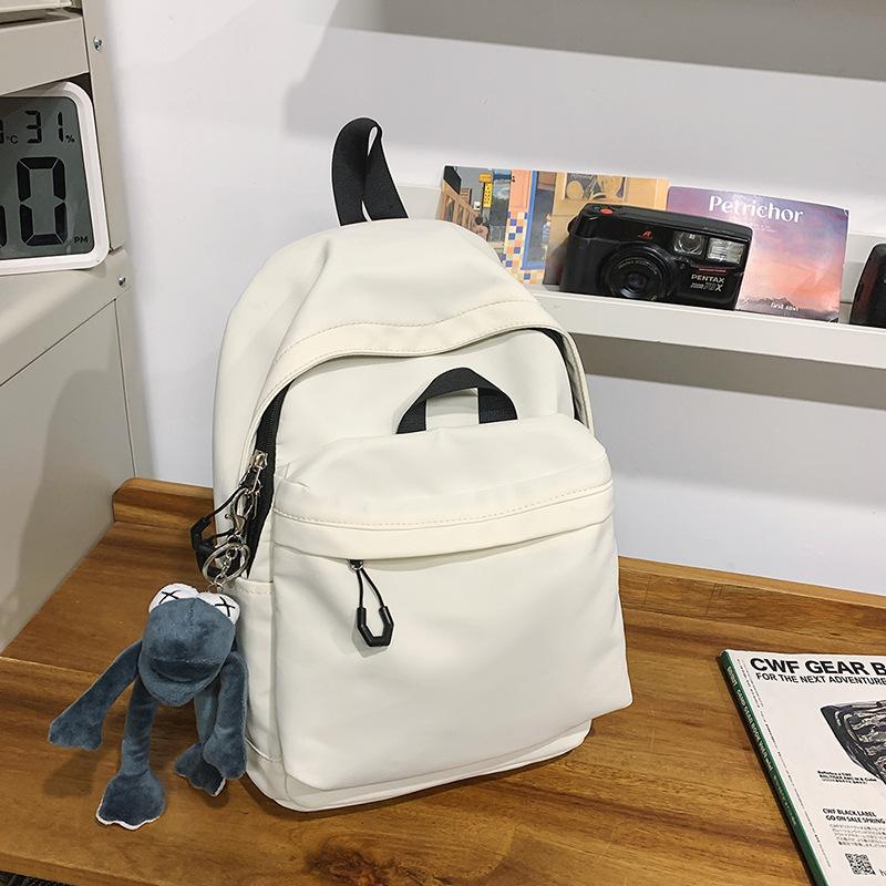 Casual large-capacity backpack fashionable outdoor lightweight junior high school students solid color simple schoolbag Korean version travel backpack
