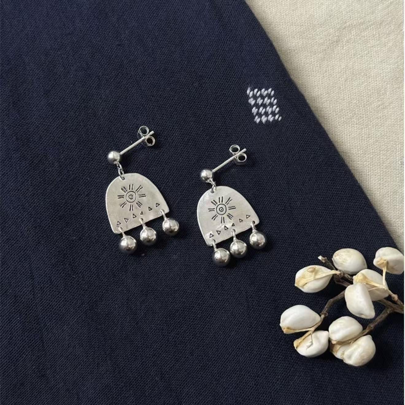 

New Year s Sun Bell Totem Stud Earrings: Retro Carved Dangle with Versatile, Unique Design.