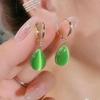 Elegant, Minimalist Drop-shaped Drop Earrings with A Double-sided Cat's Eye Stone in 18K Metal.… More