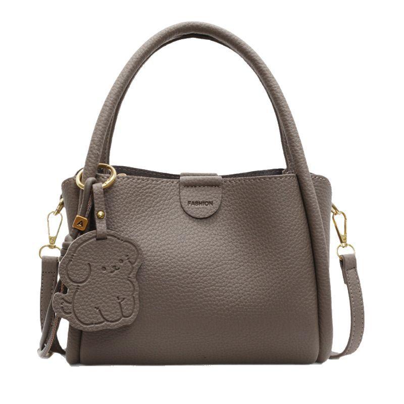 Simple design solid color handbag 2025 new Korean niche retro commuter crossbody bag textured commuter bucket bag