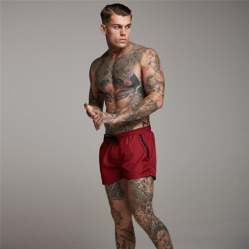 

Muscleguys, летние модные повседневные мужские свободные шорты из полиэстера на молнии, пляжные шорты для бега, тренажерного зала, фитнеса, бодибилдинга, мужские шорты XXL красный