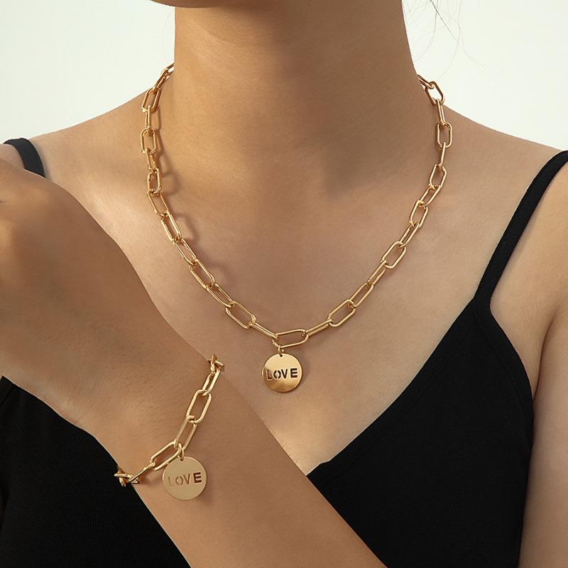 Gold round pendant with black love lettering, premium necklace and bracelet set