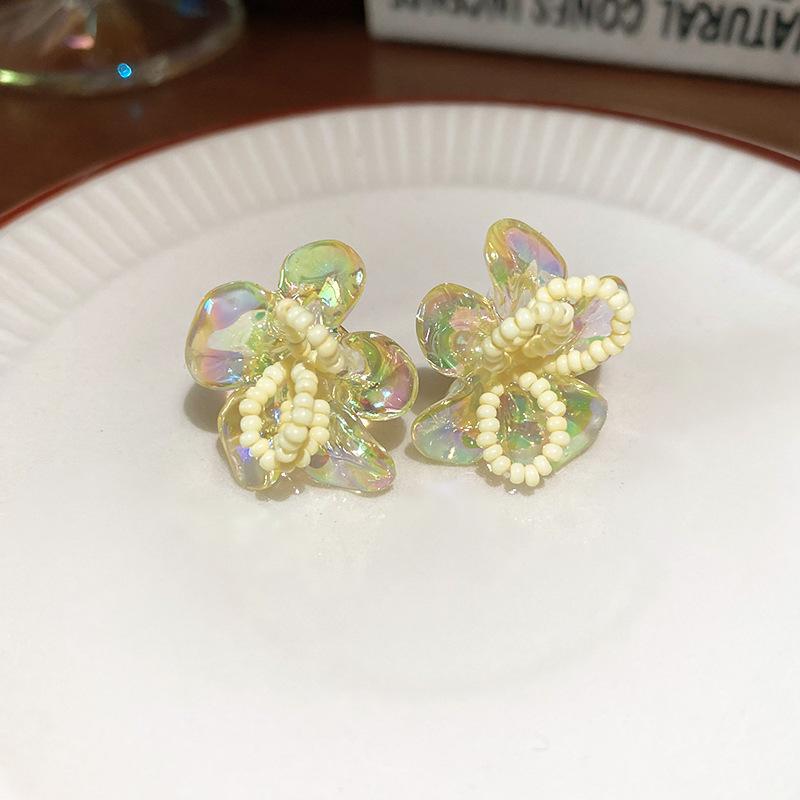 Woven rice bead flower stud earrings are small, exquisite, fashionable, simple wind earrings, niche sweet wind earrings.