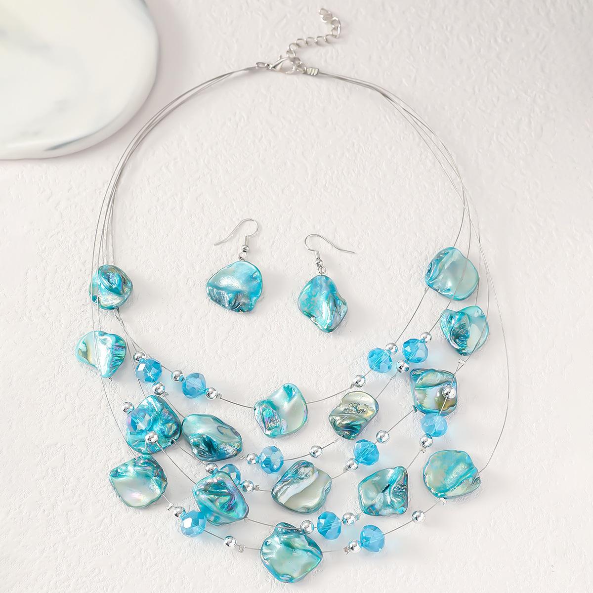 

Европейский и американский гравийный нерегулярный комплект из ожерелья и серег зелёный