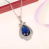 Deep Blue Teardrop Pendant Necklace with Double Sparkling Halo and Bow Accent Elegant Royal Inspired Jewelry for Women
