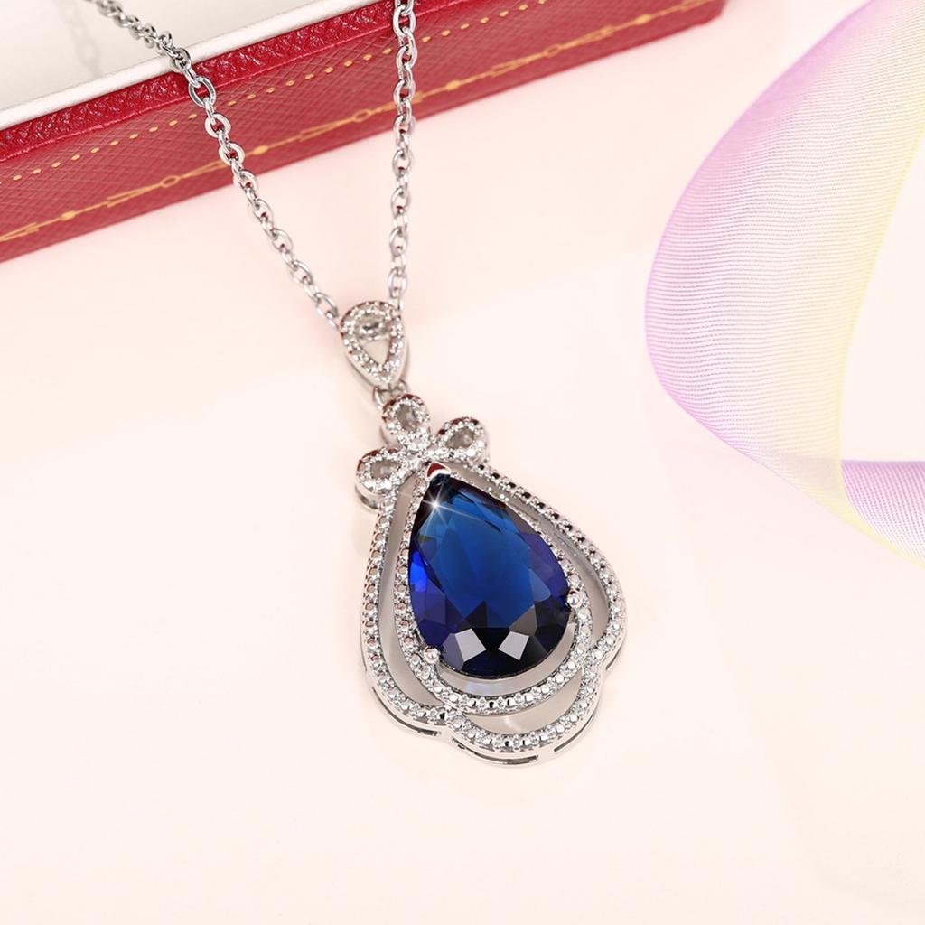 Deep Blue Teardrop Pendant Necklace with Double Sparkling Halo and Bow Accent Elegant Royal Inspired Jewelry for Women