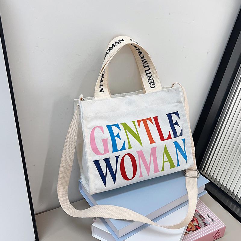 

Stylish Korean Canvas Tote Bag For Women Featuring Colorful Lettering And Cartoon Design