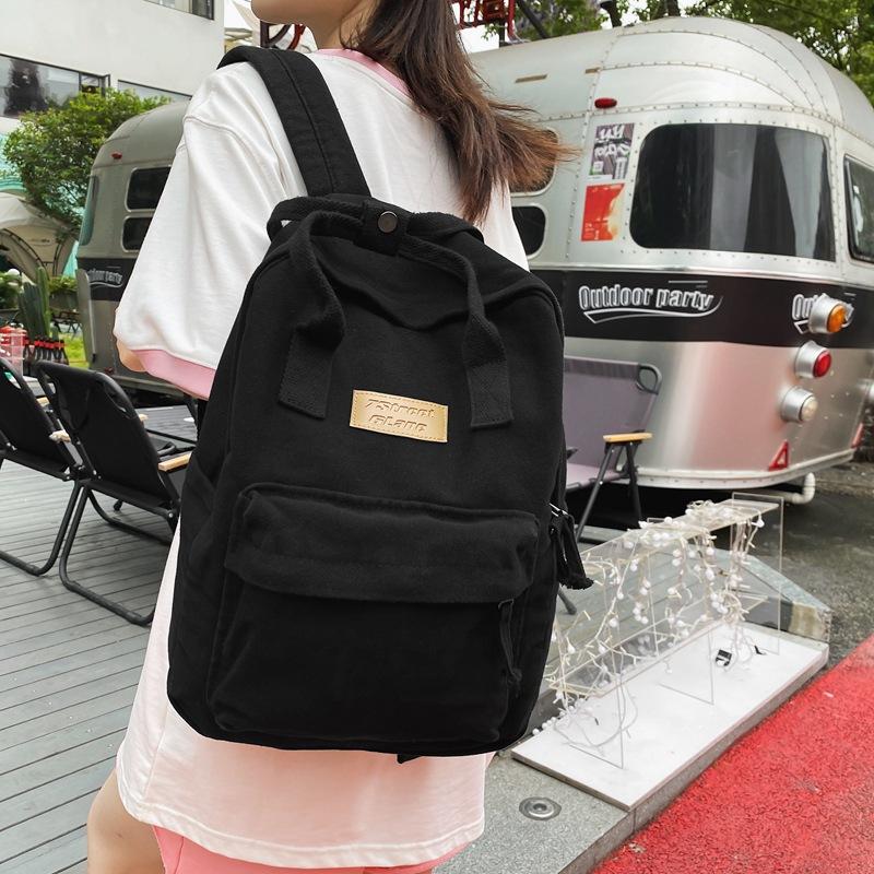 Spring and summer washed cloth labeled student schoolbag Korean version casual daily large-capacity backpack