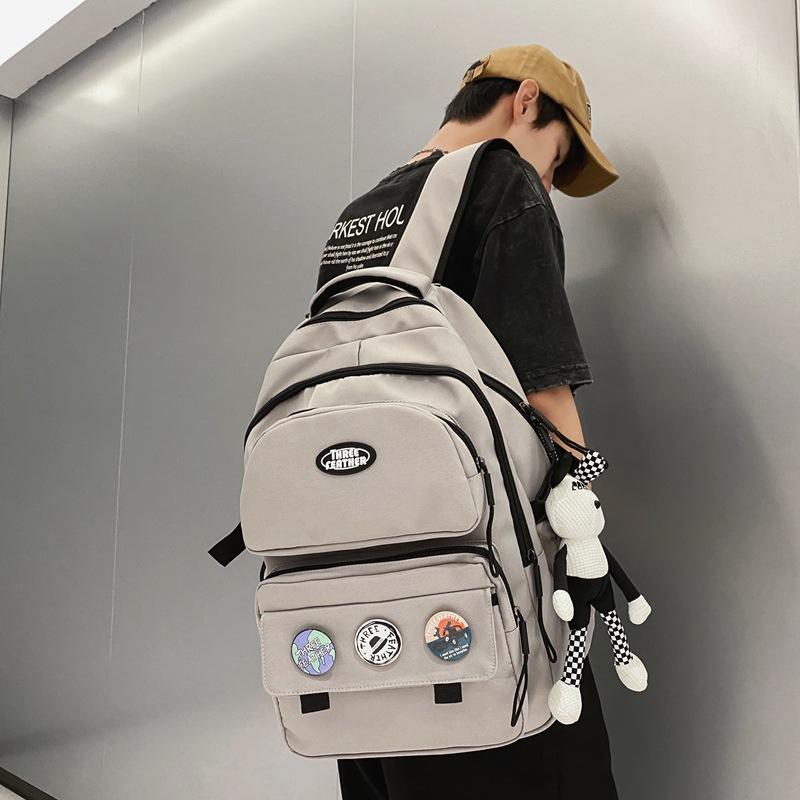 

Tooling badge ins front pocket large capacity student schoolbag college student spine care travel sports wind backpack