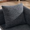 Modern single armchair with comfortable fabric backrest and two storage compartments, complemented by a practical side table.