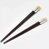 A pair of lacquered chopsticks for featuring a lucky charm design and a smiling owl presented in a paulownia wood Made in couples, motif, box. Japan.