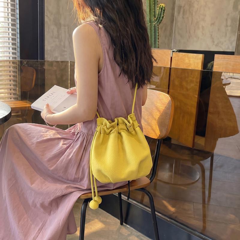 2026 New Drawstring Bucket Bag for Women Soft Leather Crossbody Bag with Ball Charm Mini Shoulder Handbag for Daily Shopping