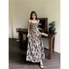 Seaside vacation floral suspender dress women's summer 2026 new Hong Kong style retro chic small man long skirt