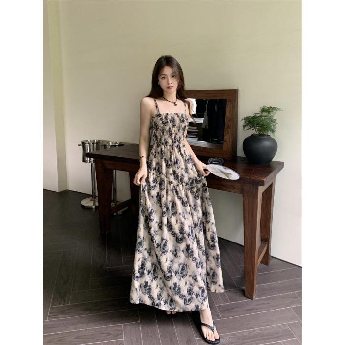 Seaside vacation floral suspender dress women's summer 2026 new Hong Kong style retro chic small man long skirt