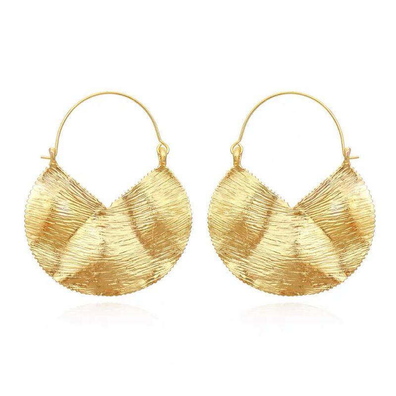 Fashion Exaggerated Heavy Industry Retro Geometric Texture Earrings The Model s Matching Golden Pair.