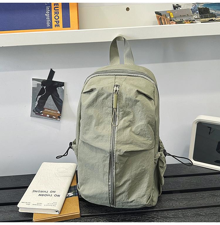 School bag Solid color outdoor mountaineering waterproof pleated backpack Lightweight leisure travel messenger bag Niche versatile simple breast bag