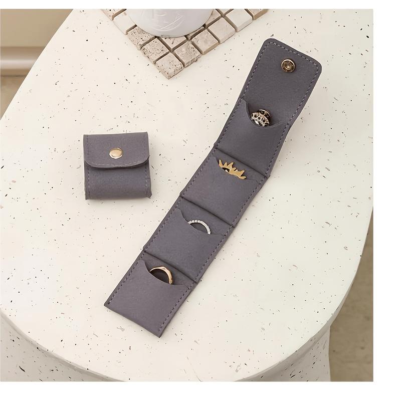 

Foldable Genuine Leather Travel Jewelry Roll—A portable jewelry organizer with multiple compartments and a snap closure. темно-сірий