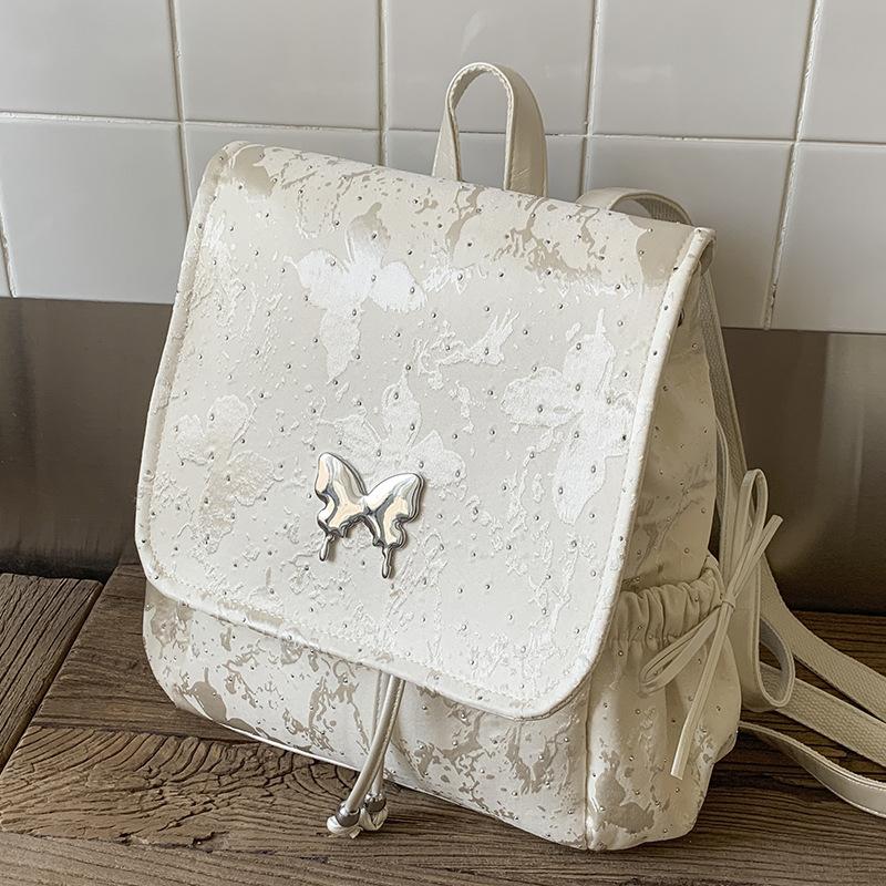 2025 new trendy silver butterfly backpack bag, student class backpack, hand-held travel bag, high-value bag.