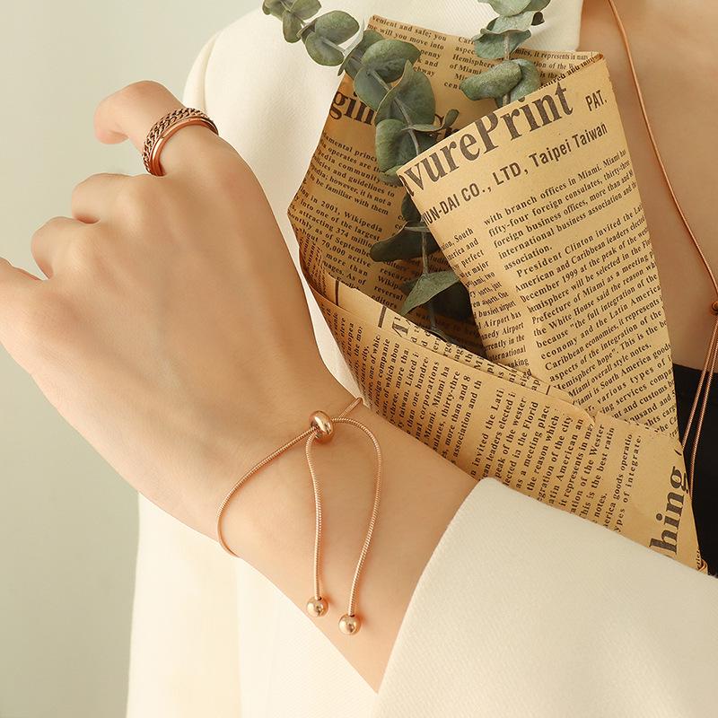 Stylish Non-Fade Round Bead Pull-Out Buckle Women’s 18K Gold-Plated Titanium Steel Jewelry Set: Tassel Necklace, Bracelet, Anklet.