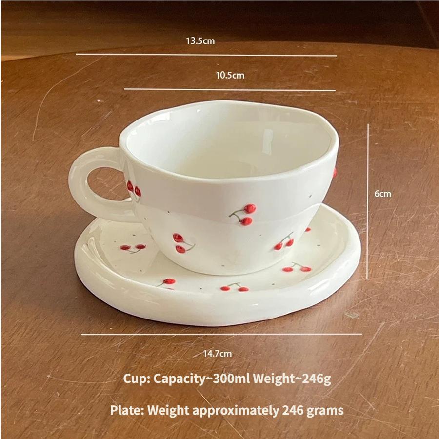 Ceramic coffee cup and saucer set, decorated with a small floral pattern.