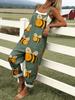 Green jumpsuit with cartoon bee pattern
