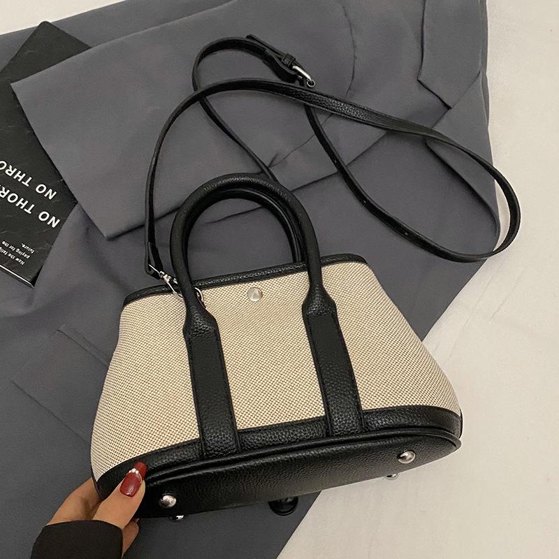 Korean version of casual niche contrasting color splicing portable bucket bag fashion versatile temperament casual commuter messenger bag woman