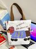 Auf Lager: Tragetasche aus Canvas mit Cartoon-Motiv – Groß, hochwertig, kleines Fassungsvermögen, niedliche Schultertasche für Pendler