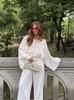 European & American Women's Fashion Tie-Up Cutout Patchwork Two-Piece Set: Round Neck Long Sleeve Top & Mini Skirt for Vacation or Casual Wear.