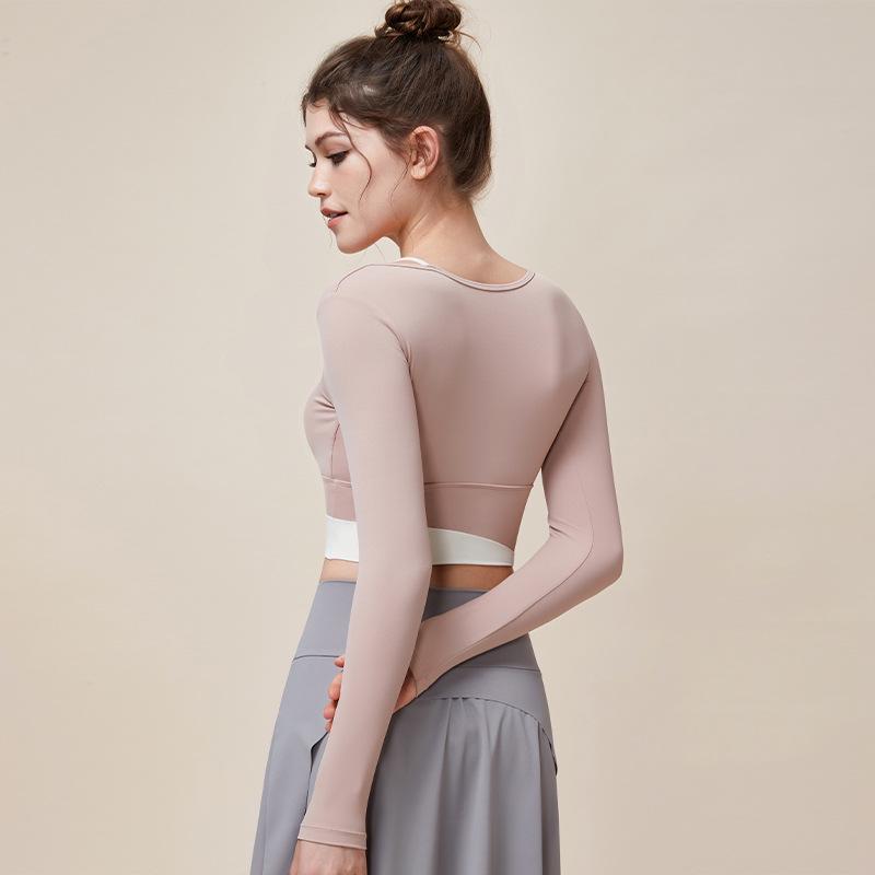 

Colorblock Faux Two-Piece Yoga Suit: High Elastic, Skin-Friendly Long Sleeve with Integrated Cup for a Nude Feel. Medium абрикосовий/рожевий