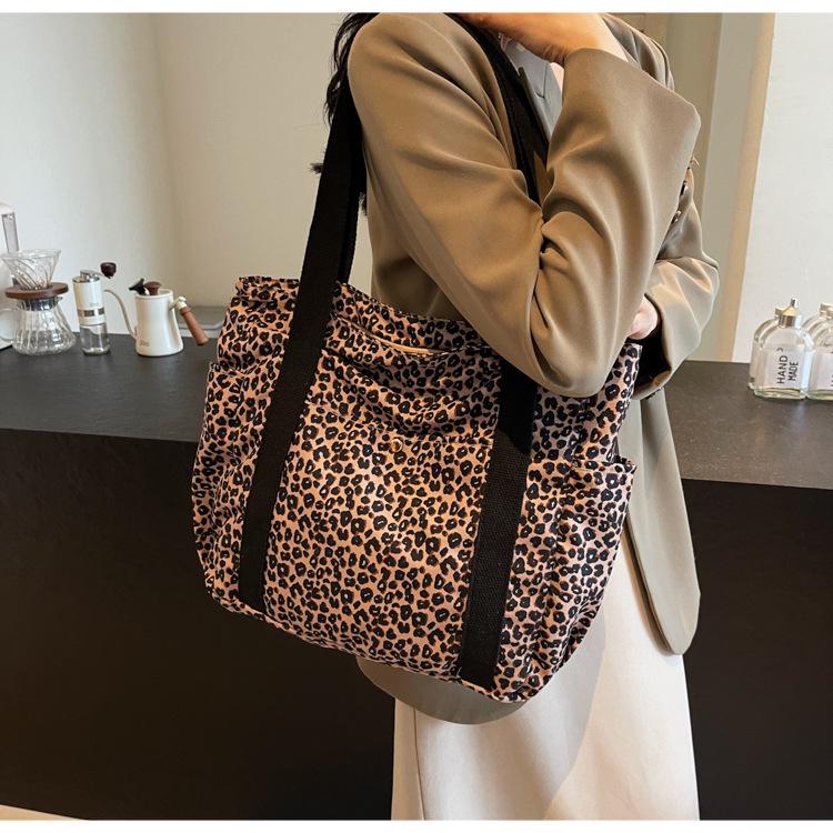 Leopard Print Canvas Tote: Large Capacity Autumn Shoulder Bag for Women, Versatile for College and Commute.