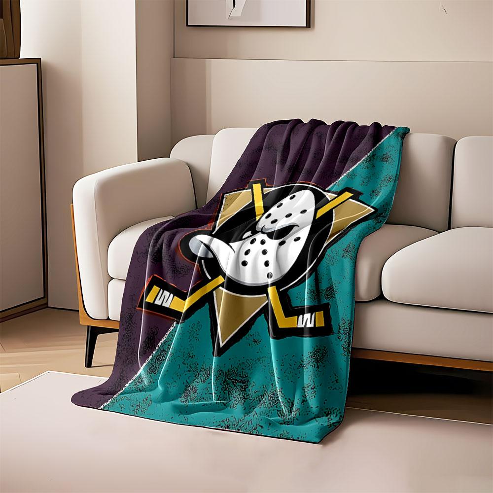 

A hockey mask with crossed sticks over a triangular background split diagonally. for all seasons blanket lunch break throw gift 80cm x 120cm