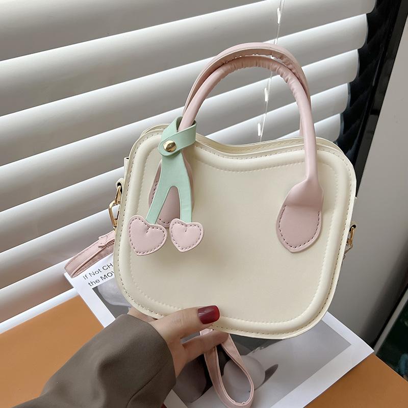 

Маленька жіноча сумка літо 2024 нова мода проста сумка через плече в іноземному стилі однотонна портативна маленька квадратна сумка рожевий