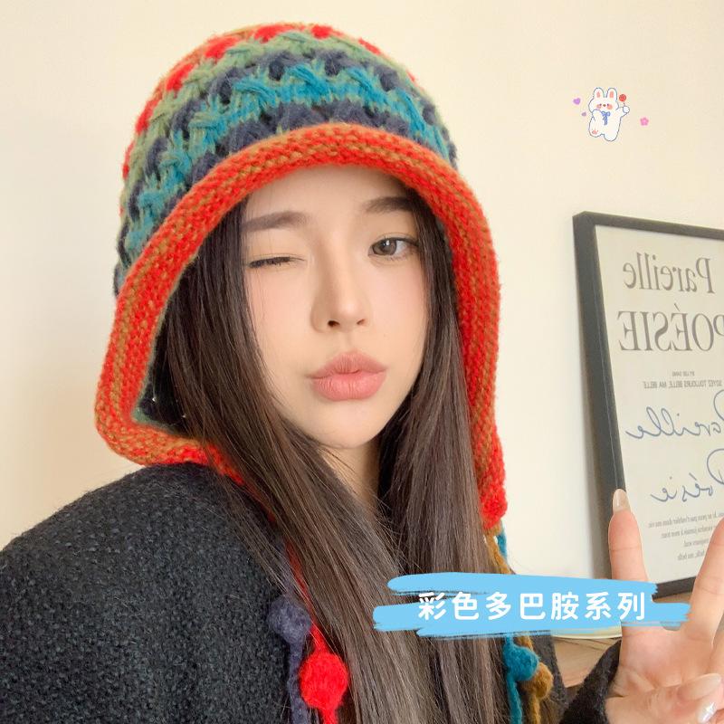 Handmade women's knitted headgear autumn and winter color fringed ball lace-up ear protector hollow knitted wool cap