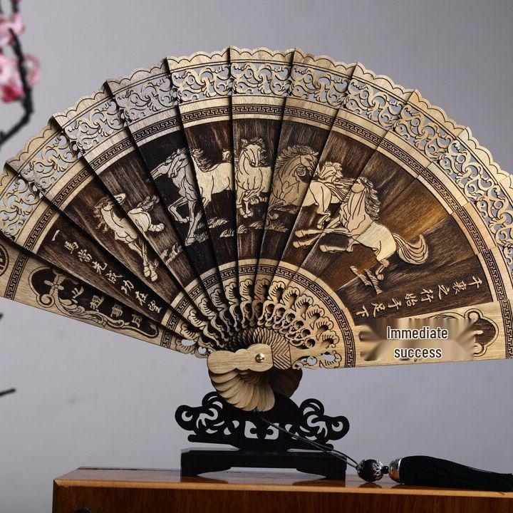 

Golden Phoebe Folding Fan: Solid Wood, Openwork Carving, Classical Chinese Style with Tassel Decoration.