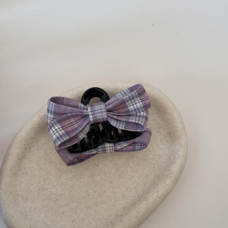 The Princess with The Checkered Bow Accessory Has A Chic Patterned Beak Hairpin At The Back of Her Head and A Hairclip.