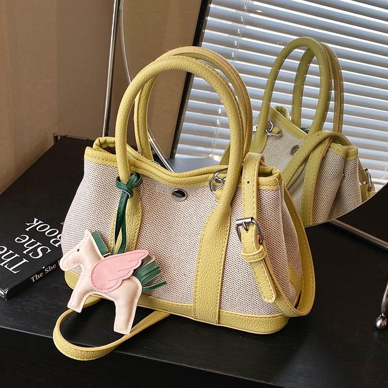 Popular niche contrasting color splicing portable bucket bag fashionable versatile high sense commuter wind messenger women's bag