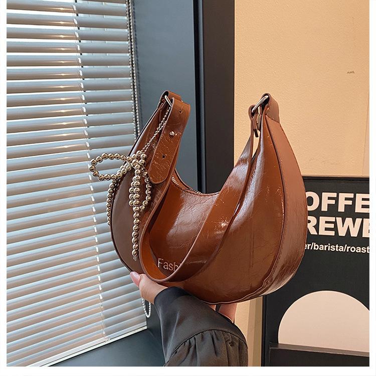 

Solid color simple foreign style bead bow 2025 autumn foreign style new Korean version one shoulder crossbody dumpling bag woman коричневый