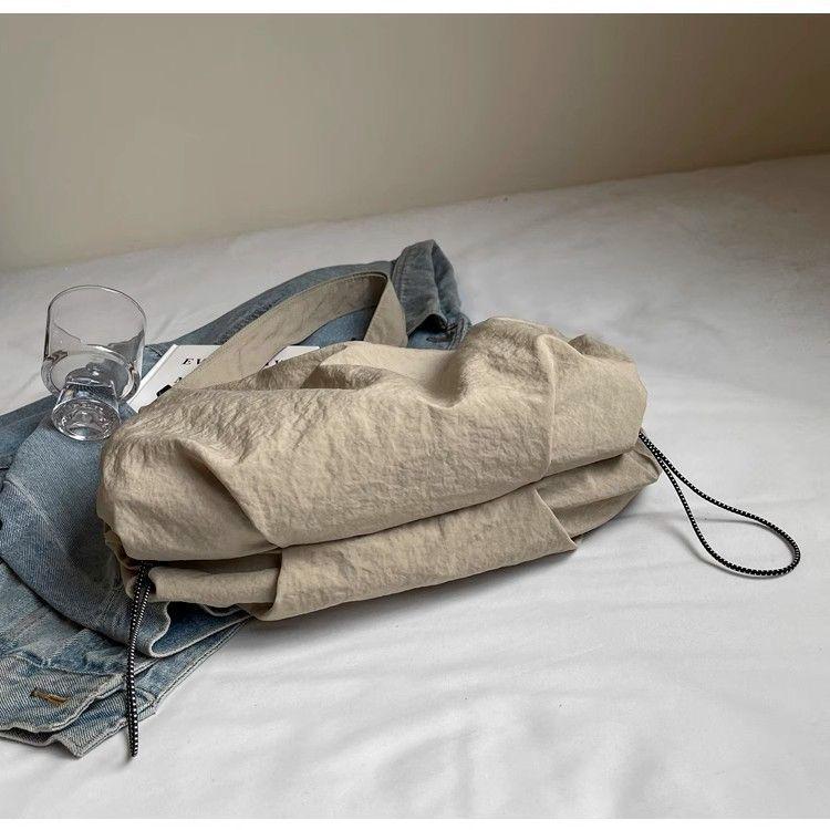 Japanese-Style Waterproof Nylon Dumpling Crossbody Bag: Sporty, Large-Capacity Tote for Men & Women, Ideal for Cycling & Relaxed Shoulder Wear.